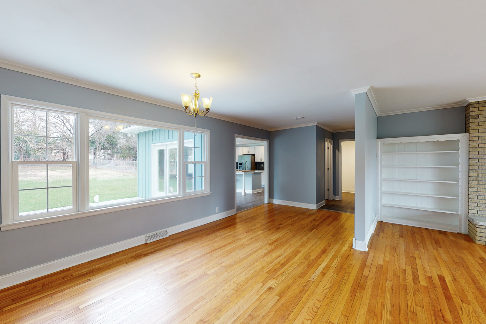 538 Russell Road DeKalb, IL 60115 - Photo 11 of 35 a view of an empty room with a window and wooden floor