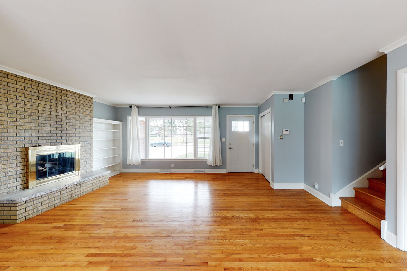 538 Russell Road DeKalb, IL 60115 - Photo 12 of 35 a view of empty room with wooden floor and fireplace
