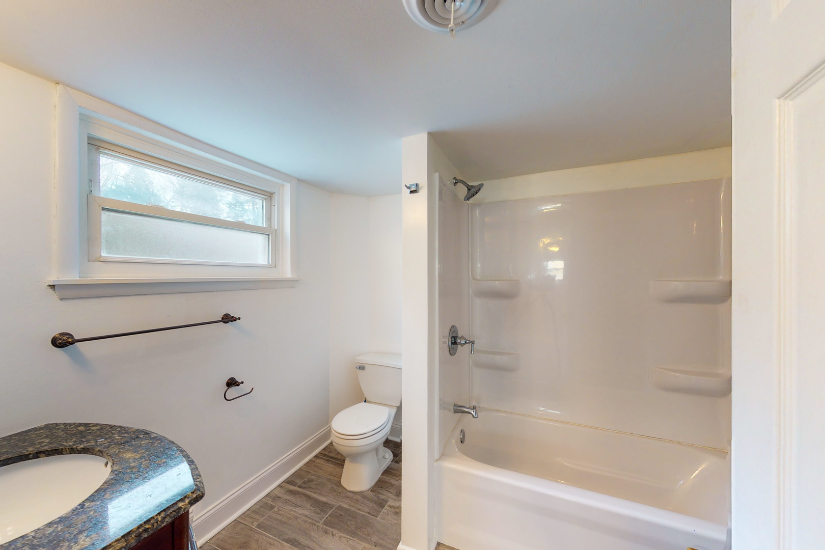538 Russell Road DeKalb, IL 60115 - Photo 16 of 35 a bathroom with a granite countertop toilet a sink and bathtub
