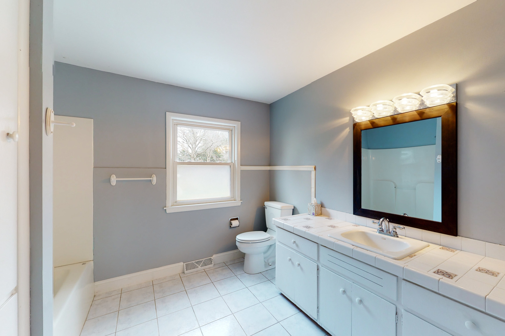 538 Russell Road DeKalb, IL 60115 - Photo 20 of 35 a bathroom with a double vanity sink and a mirror