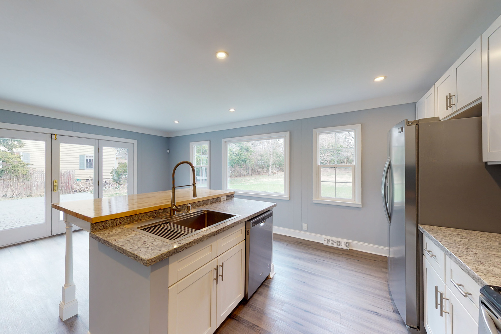 538 Russell Road DeKalb, IL 60115 - Photo 3 of 35 a kitchen that has a sink and a stove with wooden floor