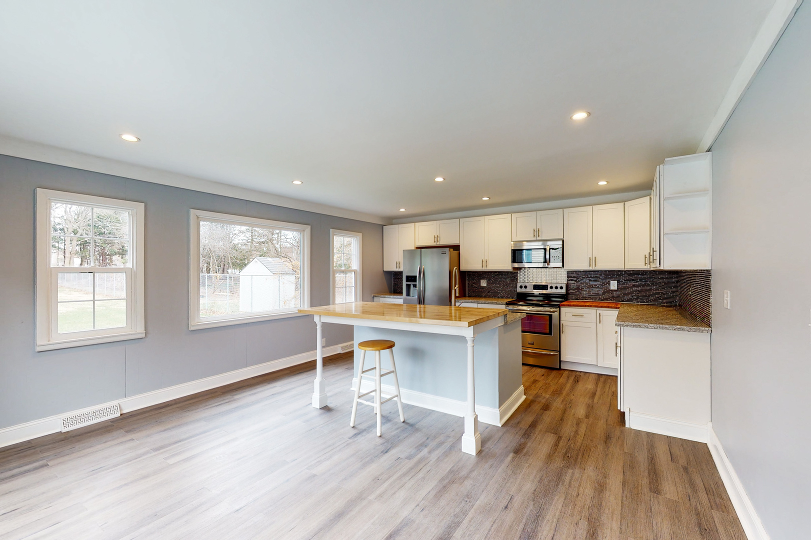 538 Russell Road DeKalb, IL 60115 - Photo 4 of 35 a kitchen with white cabinets and wooden floor