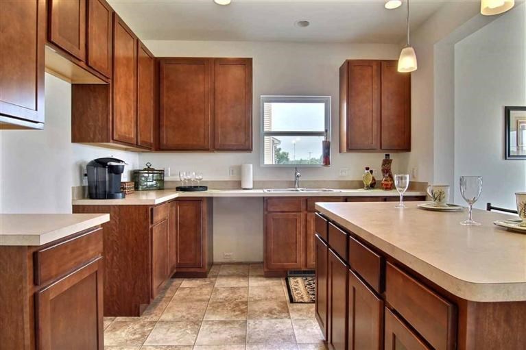 5780 Burr Rdg Circle Crown Point, IN 46307 - Photo 5 of 17 a kitchen with a sink dishwasher a stove top oven a refrigerator and cabinets