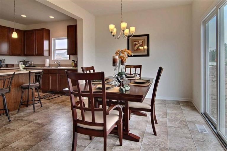 5780 Burr Rdg Circle Crown Point, IN 46307 - Photo 8 of 17 a view of a dining room with furniture and chandelier