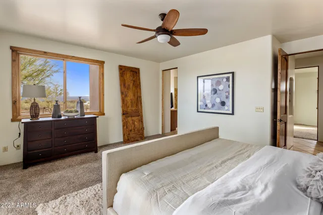 a bedroom with a bed and a large mirror