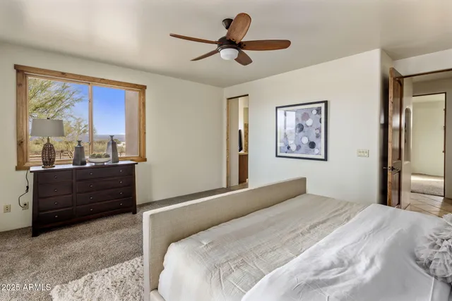 a bedroom with a bed and a large mirror