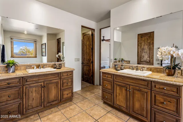 a spacious bathroom with a double vanity sink double and mirror