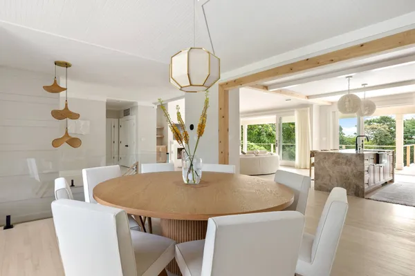 a dining room with furniture a chandelier and wooden floor