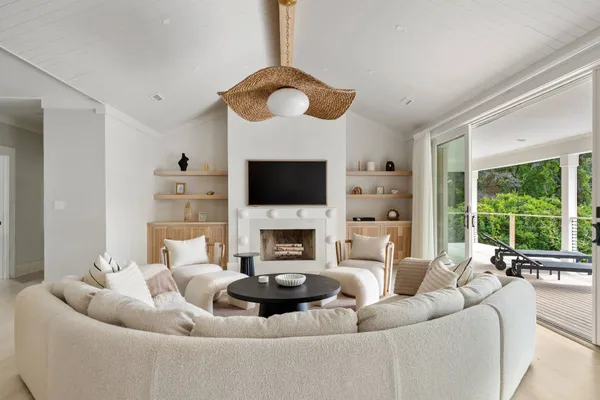 a living room with furniture a fireplace and a flat screen tv