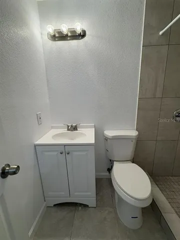 a white toilet sitting next to a bathroom sink