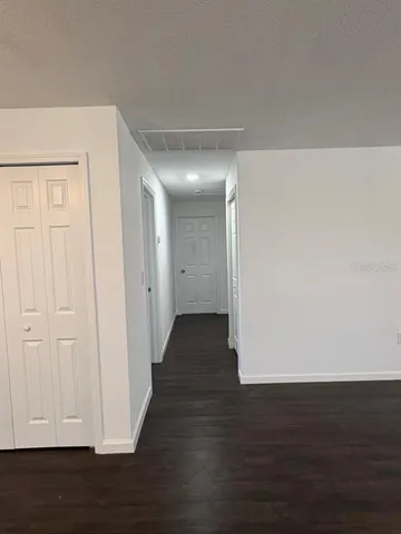 a view of a hallway with wooden floor
