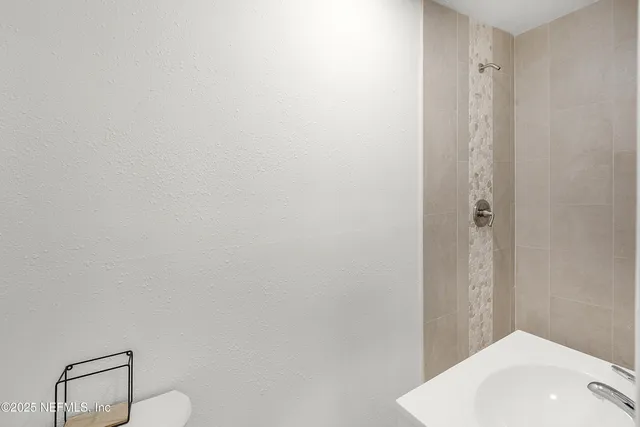 a bathroom with a sink and shower