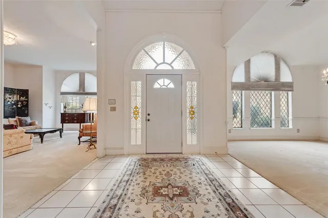 a spacious bedroom with a bed mirror and a desk