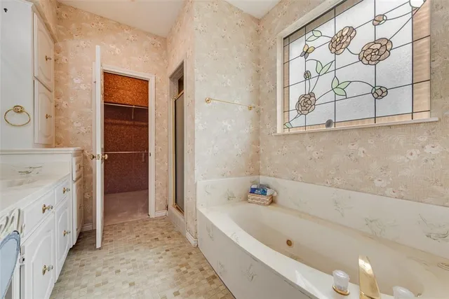 a spacious bathroom with a double vanity sink and a mirror