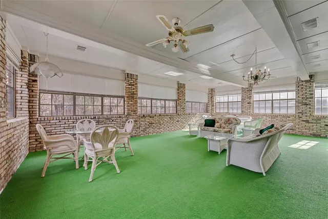 a living room with fireplace furniture and a rug