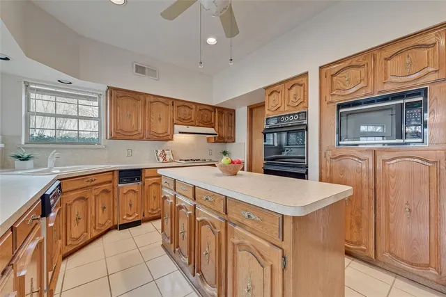 a dining room with furniture a chandelier and wooden floor