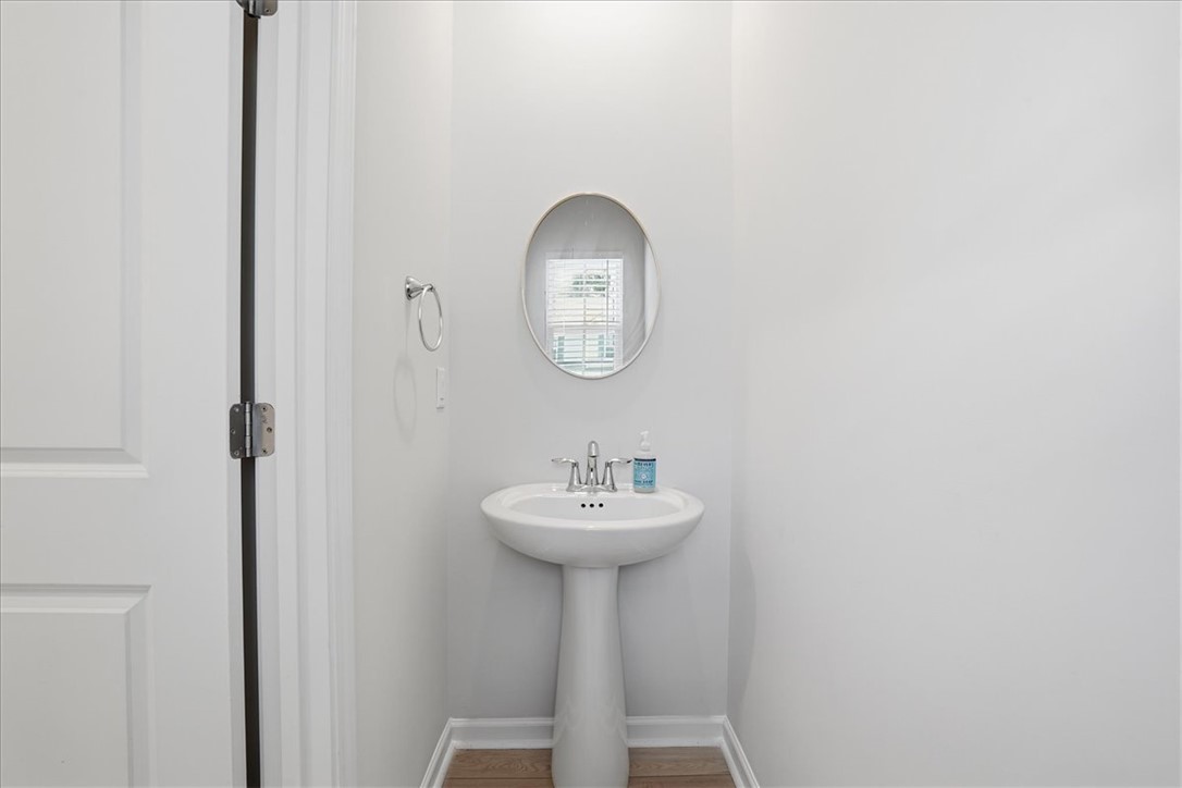 365 Sliding Rock Drive Pendleton, SC 29670 - Photo 5 of 46 A sleek pedestal sink is perfectly complemented by an oval mirror, offering essential functionality.