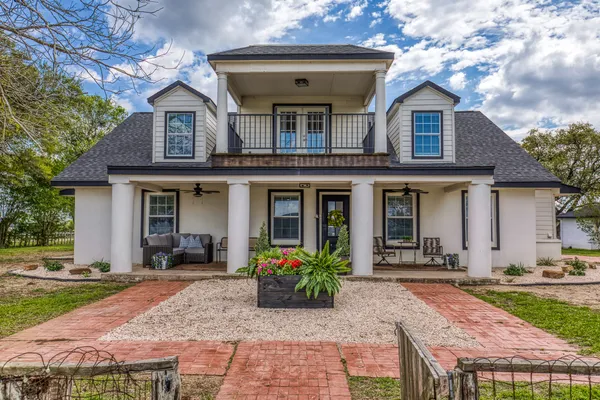 a front view of a house with garden
