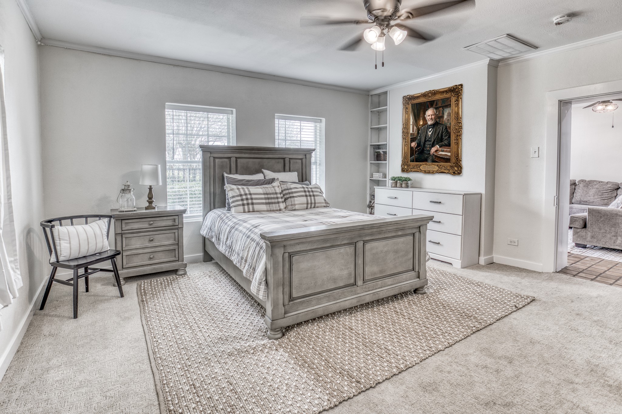 1289 Bluebonnet Ridge Drive Chappell Hill, TX 77426 - Photo 14 of 44 a bedroom with a bed a chandelier and a dresser