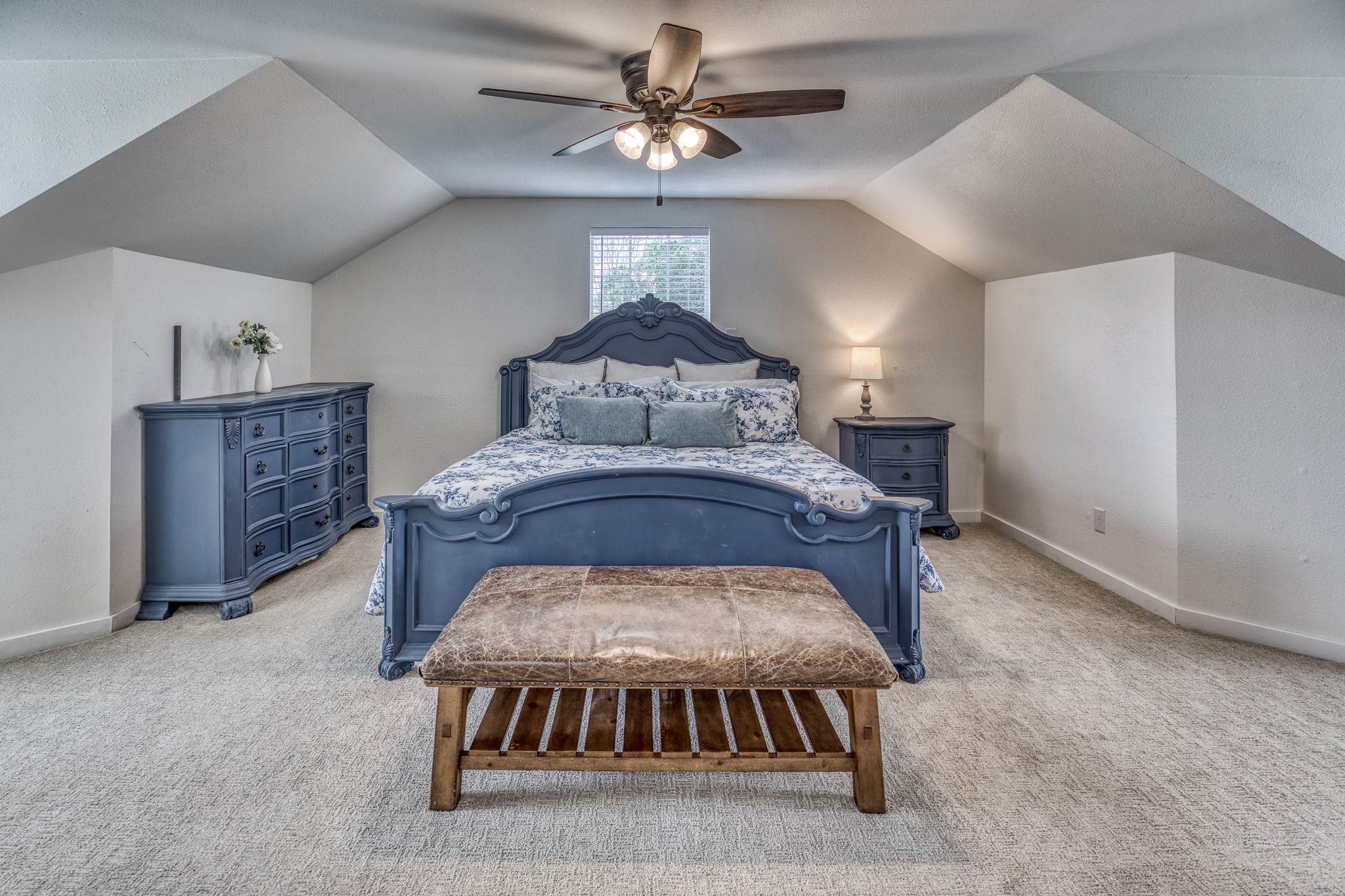 1289 Bluebonnet Ridge Drive Chappell Hill, TX 77426 - Photo 15 of 44 a bed sitting in a room next to a lamp and a chandelier