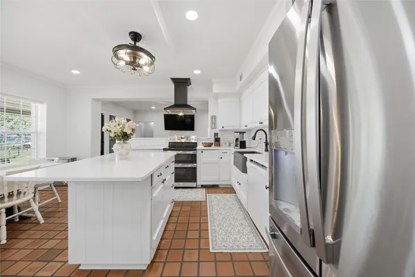 a kitchen with a sink stainless steel appliances and cabinets