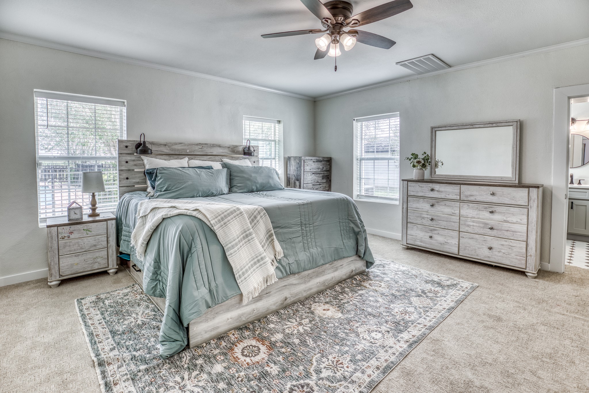1289 Bluebonnet Ridge Drive Chappell Hill, TX 77426 - Photo 9 of 44 a spacious bedroom with a bed a dresser and next to a window