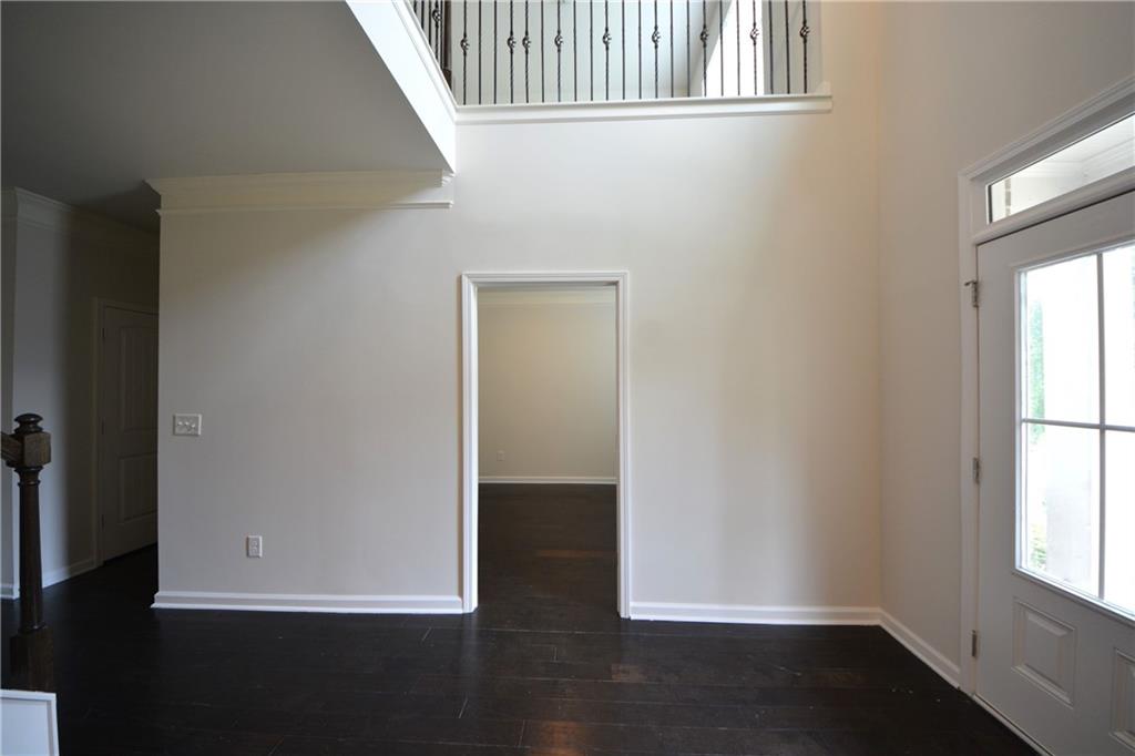 2467 Overlook Avenue Lithonia, GA 30058 - Photo 13 of 51 an empty room with wooden floor and windows