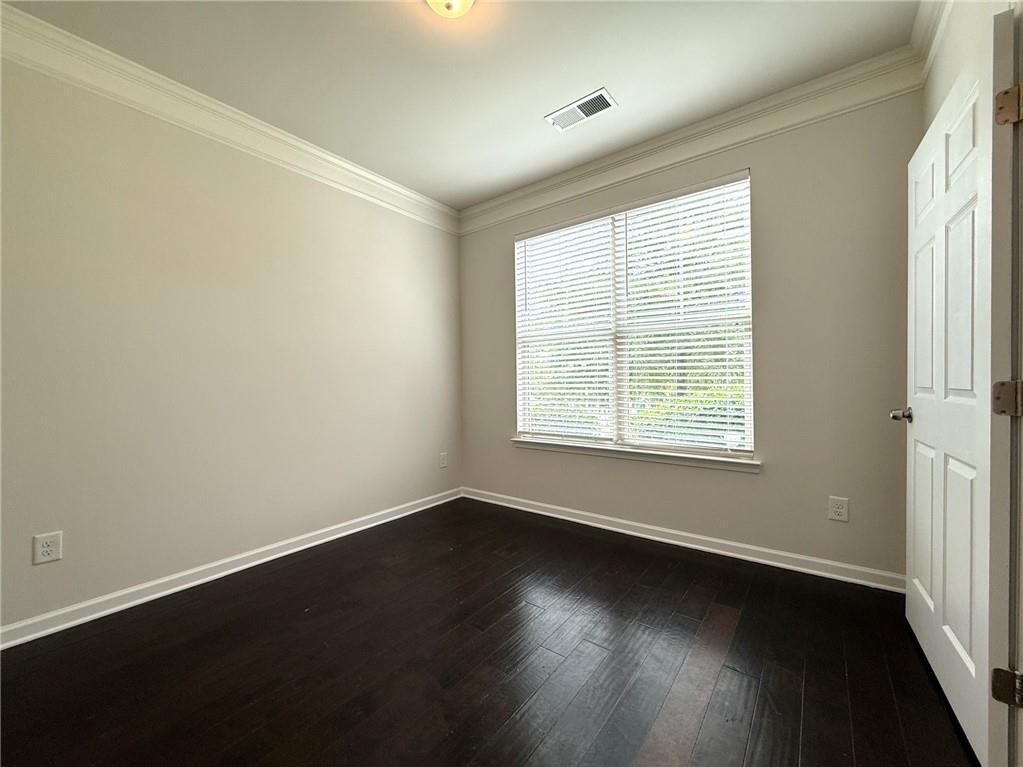 2467 Overlook Avenue Lithonia, GA 30058 - Photo 15 of 51 an empty room with wooden floor and windows