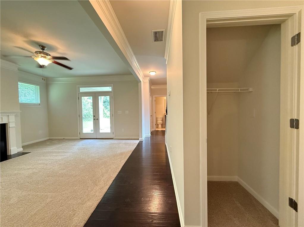 2467 Overlook Avenue Lithonia, GA 30058 - Photo 20 of 51 a view of a hallway with wooden floor and a chandelier