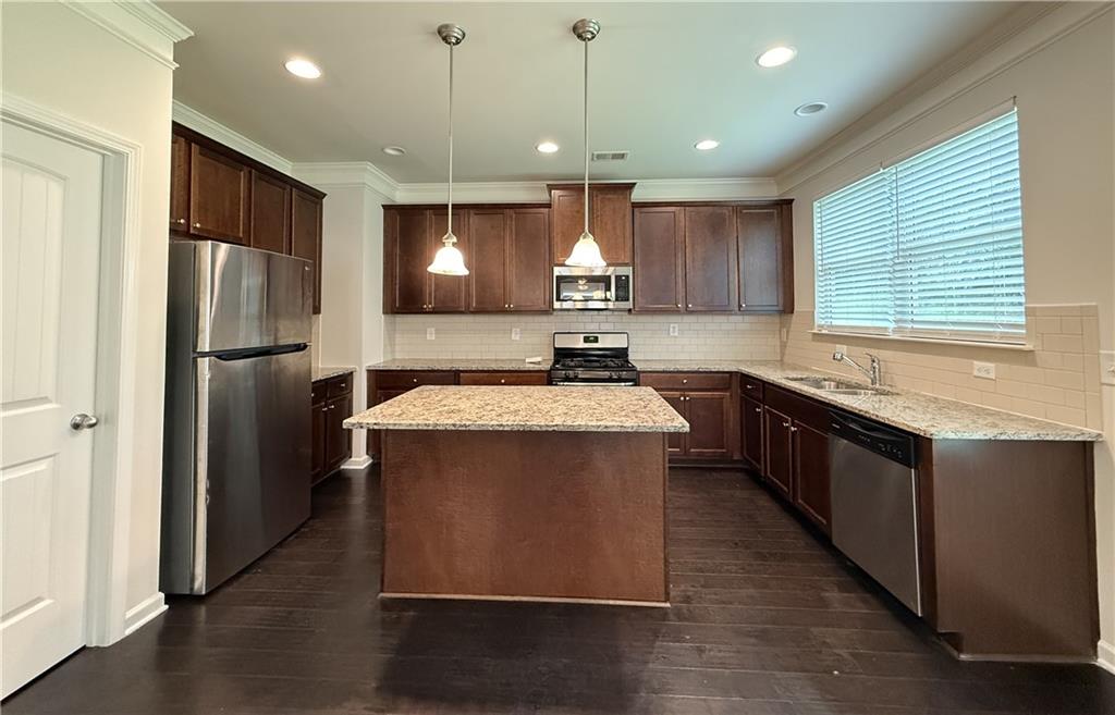2467 Overlook Avenue Lithonia, GA 30058 - Photo 28 of 51 a kitchen with stainless steel appliances granite countertop a refrigerator a sink dishwasher a stove and a refrigerator with wooden floor