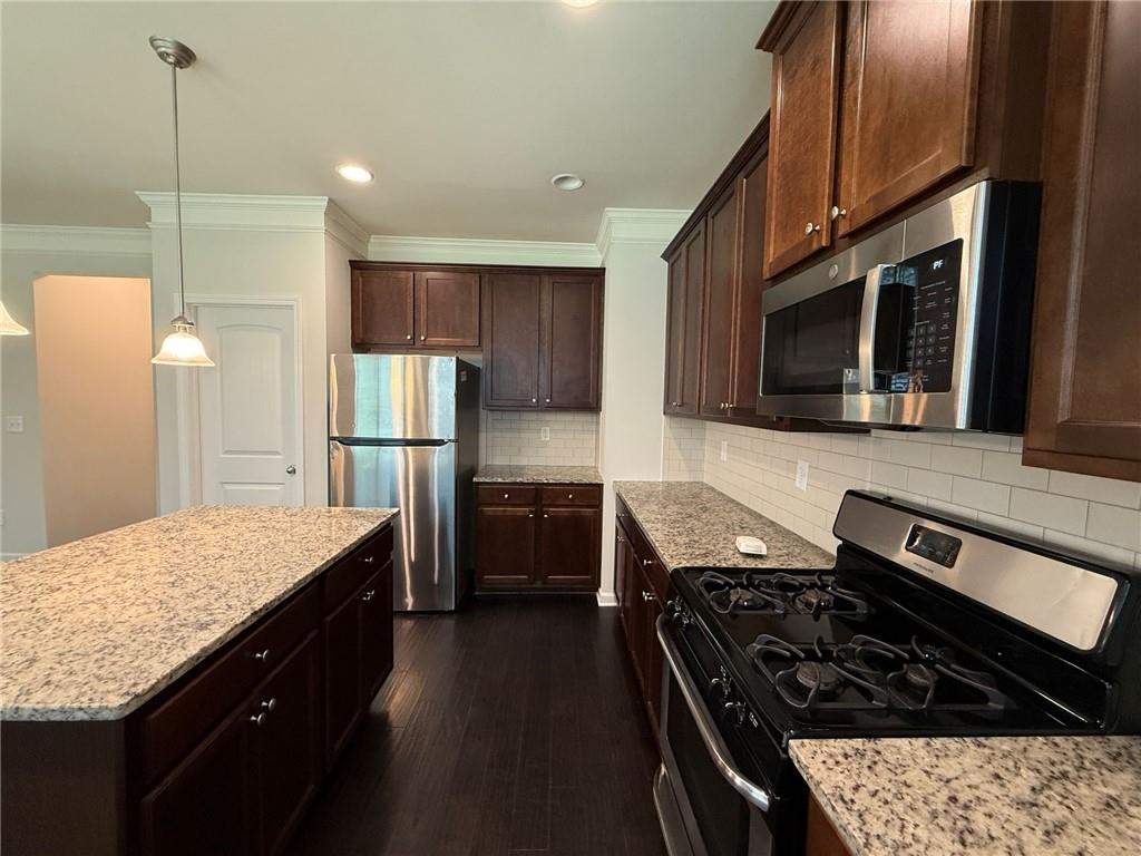 2467 Overlook Avenue Lithonia, GA 30058 - Photo 30 of 51 a kitchen with stainless steel appliances granite countertop a stove refrigerator sink and microwave