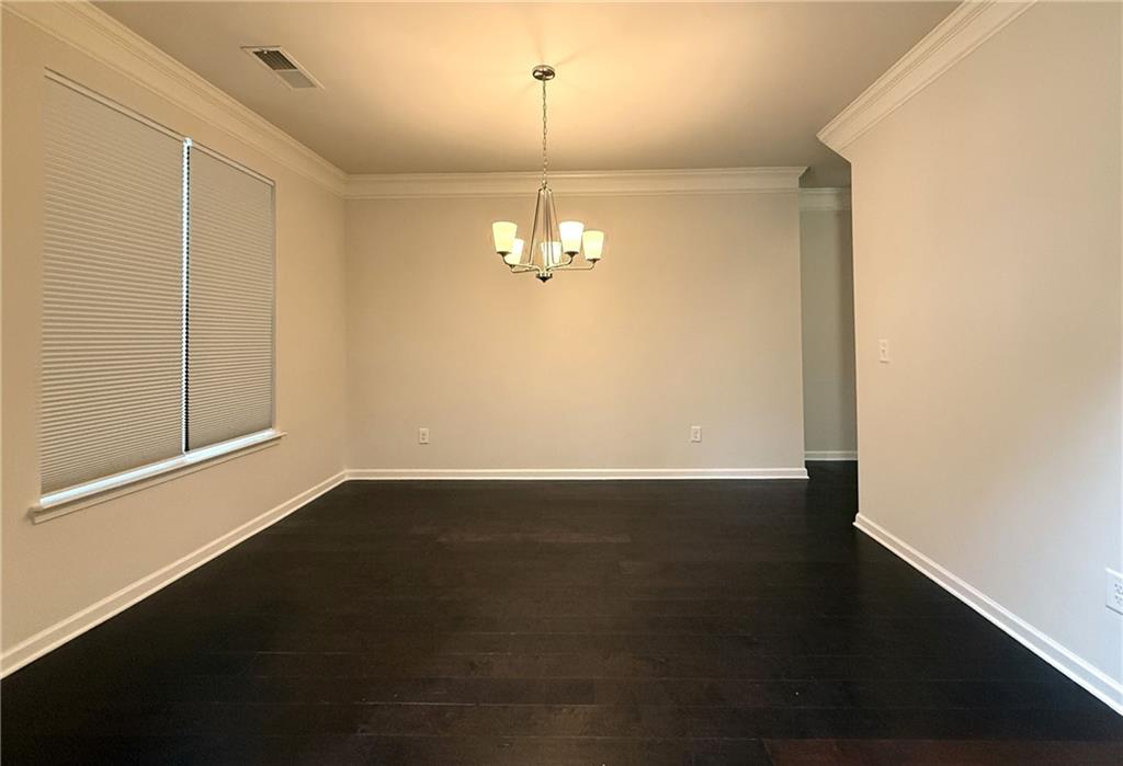 2467 Overlook Avenue Lithonia, GA 30058 - Photo 10 of 51 an empty room with wooden floor and windows