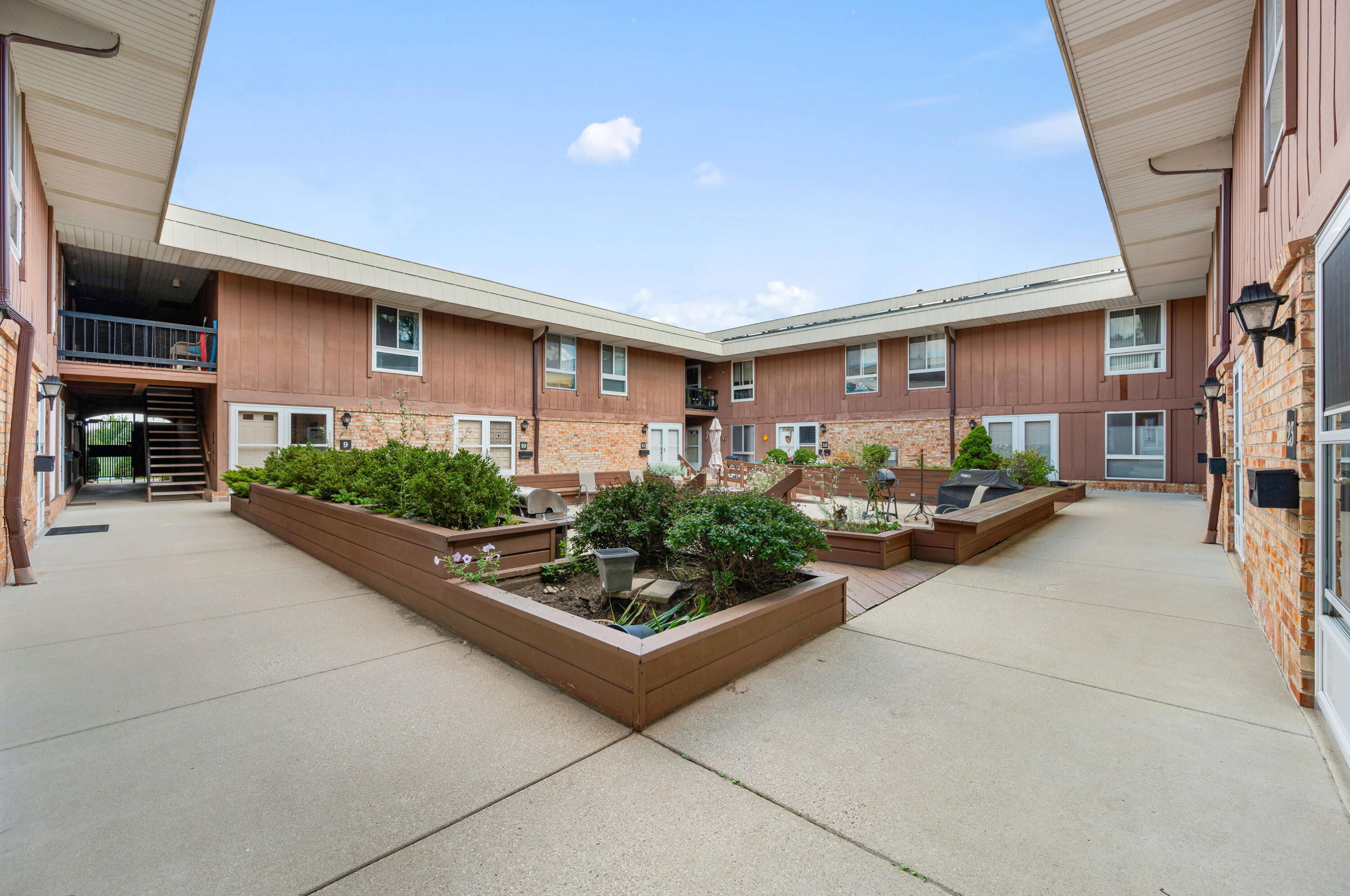 11958 West Mill Road, Unit 19 Milwaukee, WI 53225 - Photo 4 of 30 Mill Valley is renovating the courtyard replacing the wood with composite wood, new plantings, gas grills allowed and they are refurbishing the patio furniture!