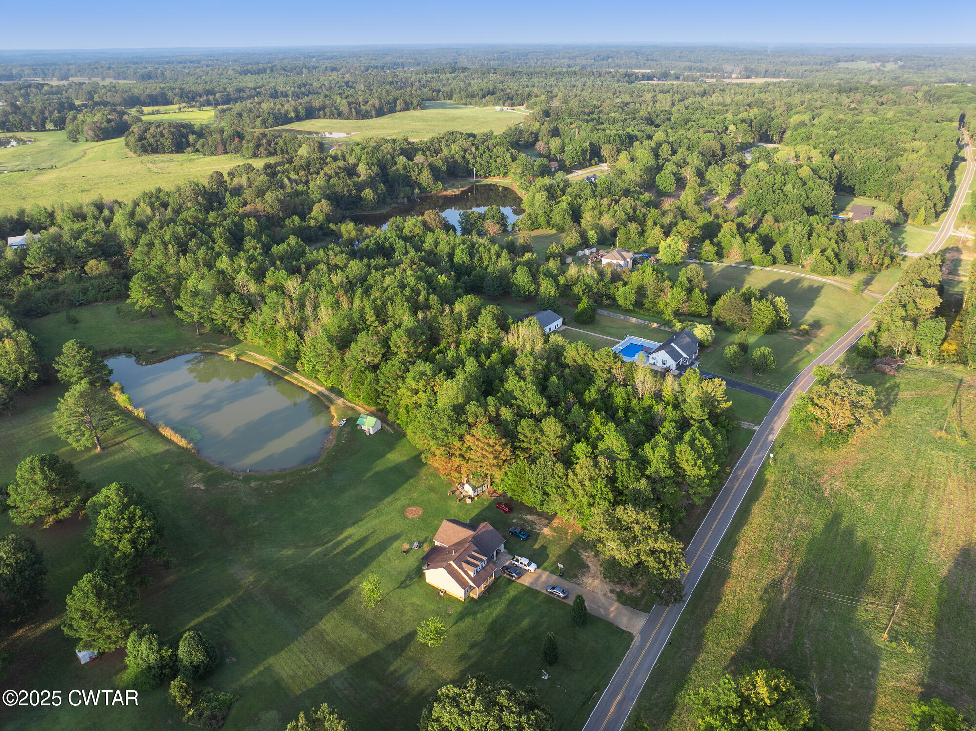 0 Sand Ridge Road Huron, TN 38345 - Photo 5 of 11 an aerial view of residential houses with outdoor space and trees