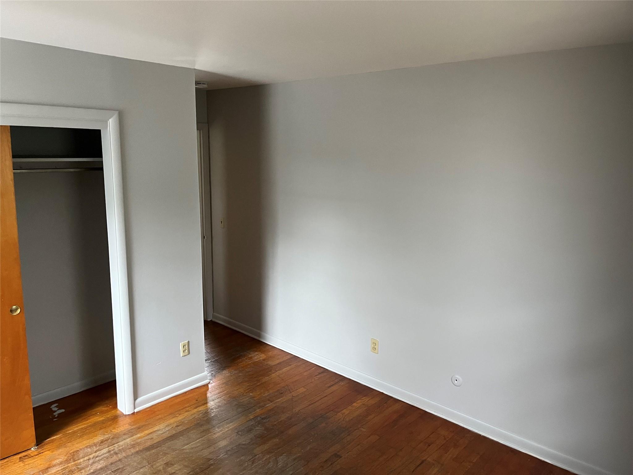 96 South Hamilton Street, Unit B6 Poughkeepsie, NY 12601 - Photo 7 of 9 an empty room with wooden floor and closet