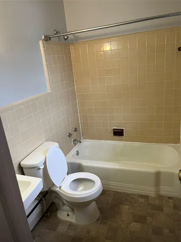 a bathroom with a toilet a sink and a bathtub