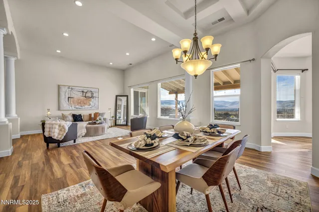 a view of a dining room with furniture wooden floor and chandelier