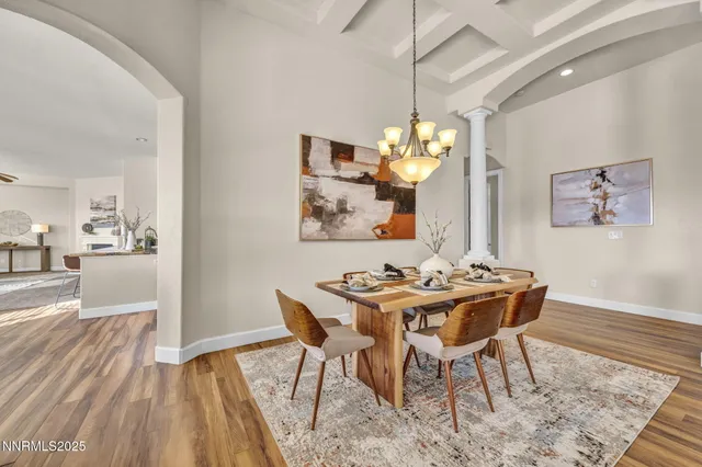 a view of a dining room with furniture and chandelier