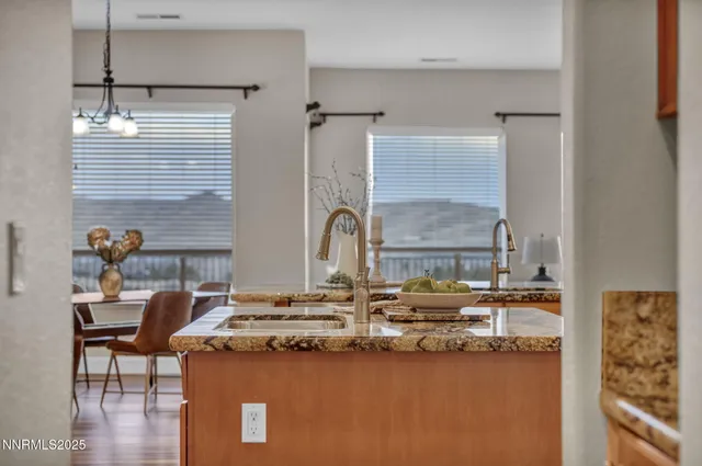 a kitchen with stainless steel appliances granite countertop a sink stove and cabinets