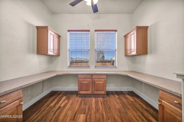 a view of a room with a ceiling fan and a window