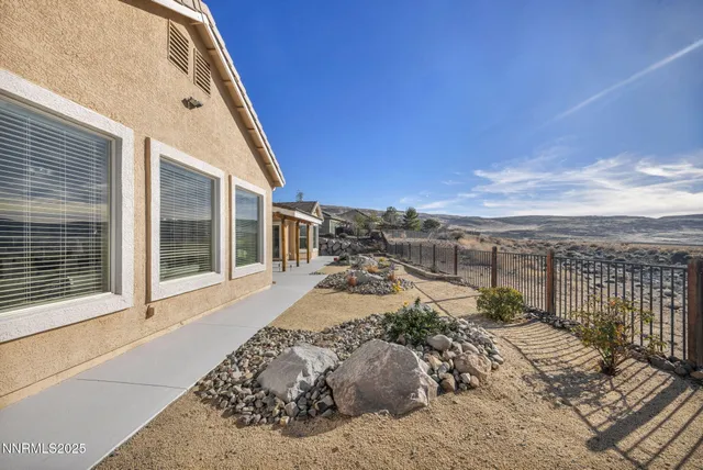 a view of an empty room with a fireplace and a window