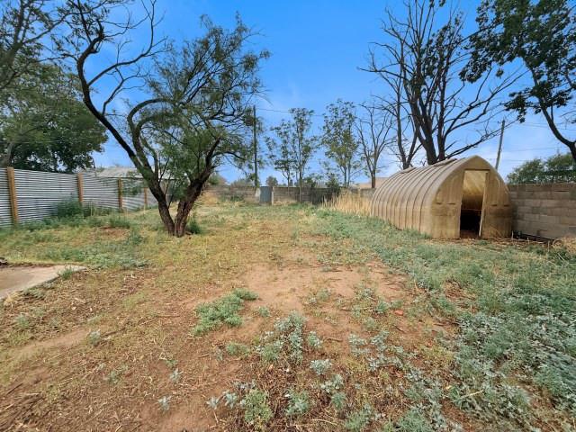 1001 North 3rd Street Lamesa, TX 79331 - Photo 4 of 32 a view of backyard with tree