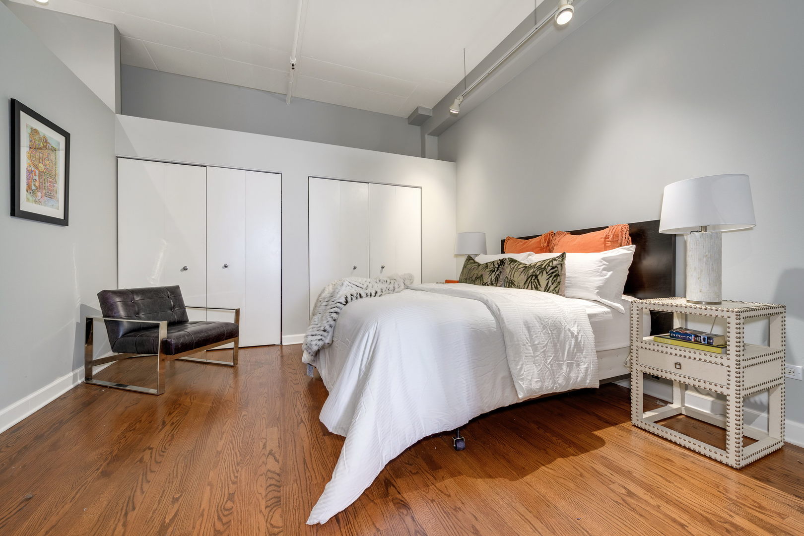 1301 West Madison Street, Unit 520 Chicago, IL 60607 - Photo 11 of 17 a bedroom with a bed and a chair