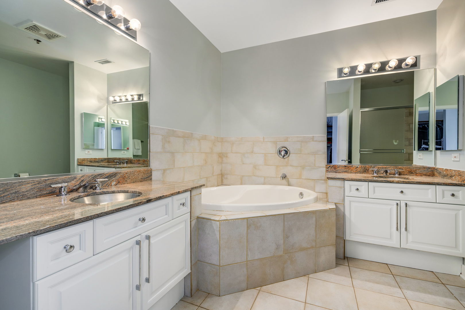 1301 West Madison Street, Unit 520 Chicago, IL 60607 - Photo 13 of 17 a bathroom with a sink vanity and mirror