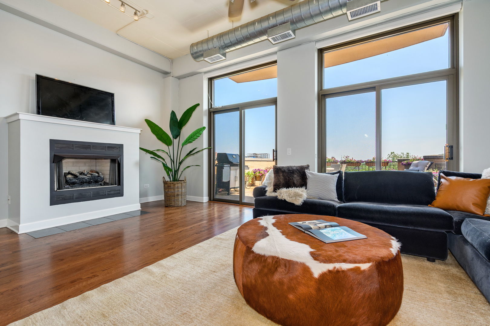 1301 West Madison Street, Unit 520 Chicago, IL 60607 - Photo 5 of 17 a living room with furniture and a fireplace