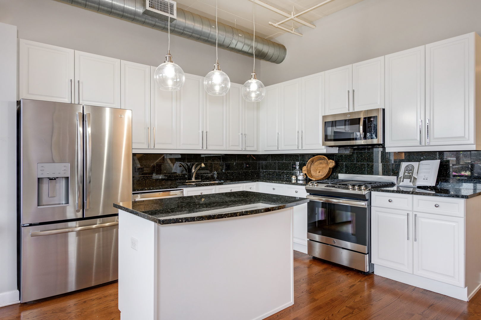 1301 West Madison Street, Unit 520 Chicago, IL 60607 - Photo 7 of 17 a kitchen with a refrigerator sink and microwave
