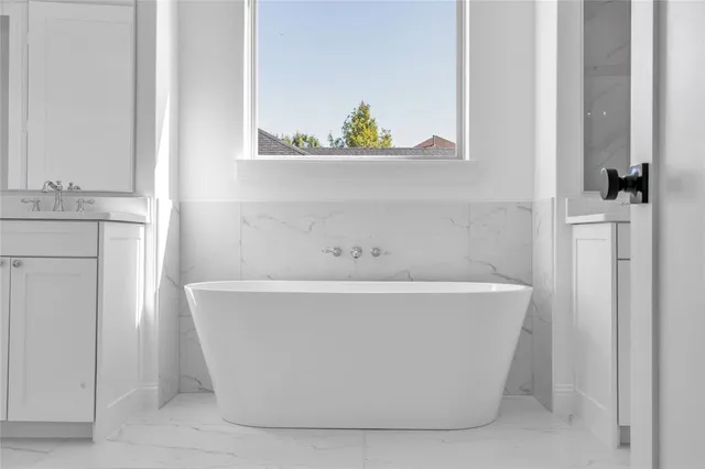 a white bath tub sitting in a bathroom