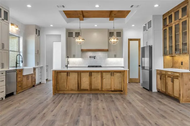 a bathroom with a granite countertop sink mirror vanity and bathtub