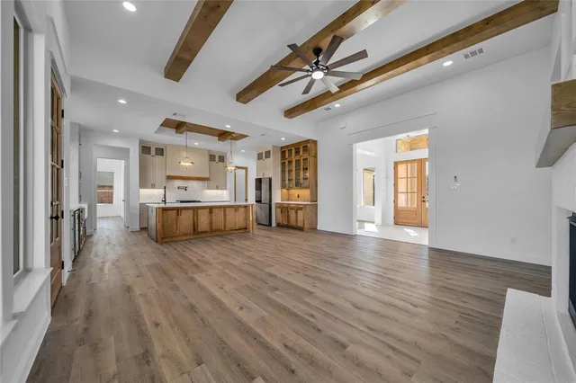 a view of a kitchen with a sink and a refrigerator
