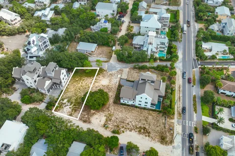 an aerial view of a house with a yard basket ball court and outdoor seating